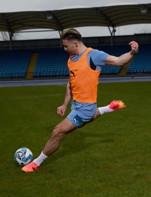 Jack Grealish portant des écouteurs oreilles libres Bose Ultra sur le terrain de soccer 