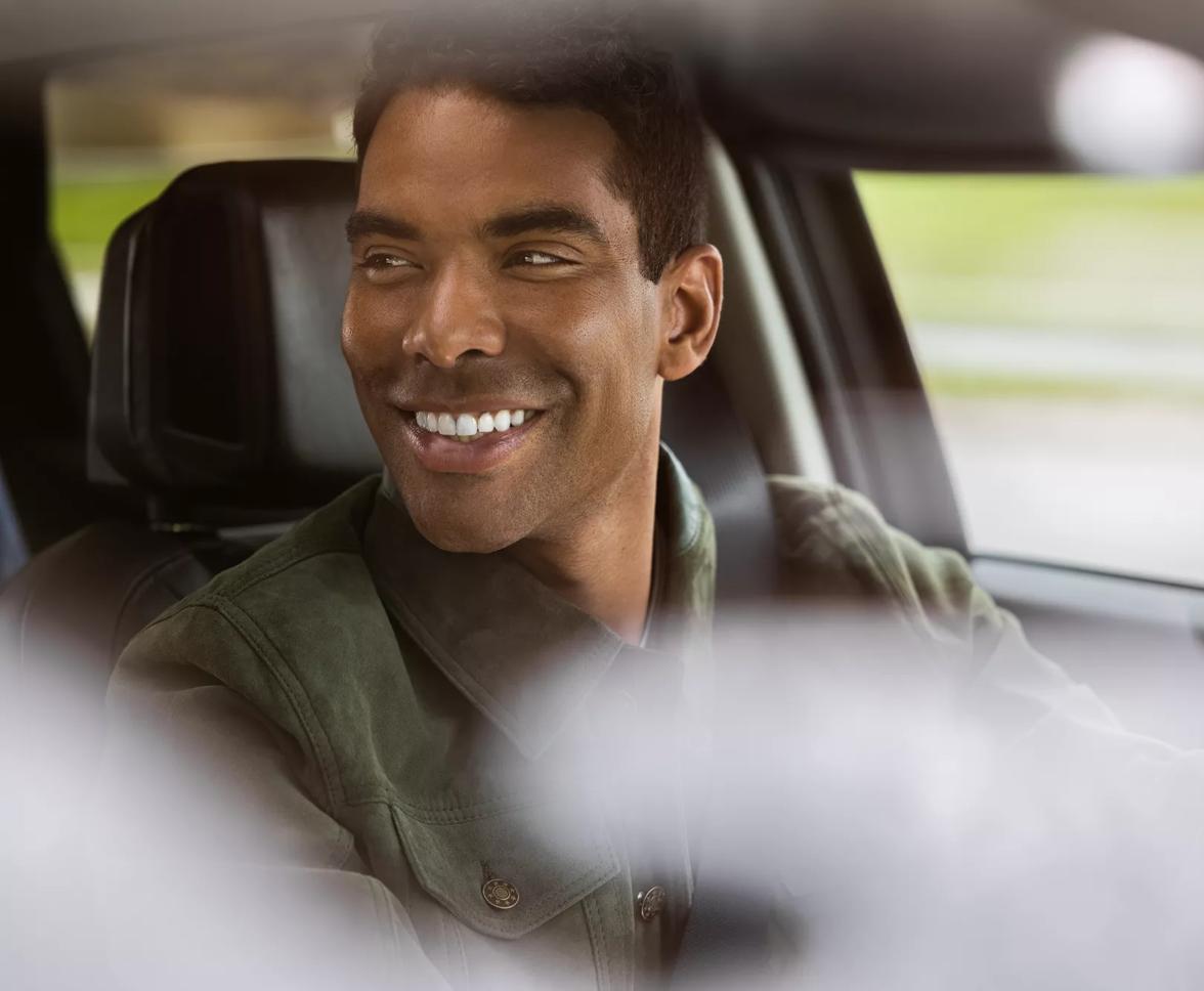 Man driving an automobile with Bose speakers