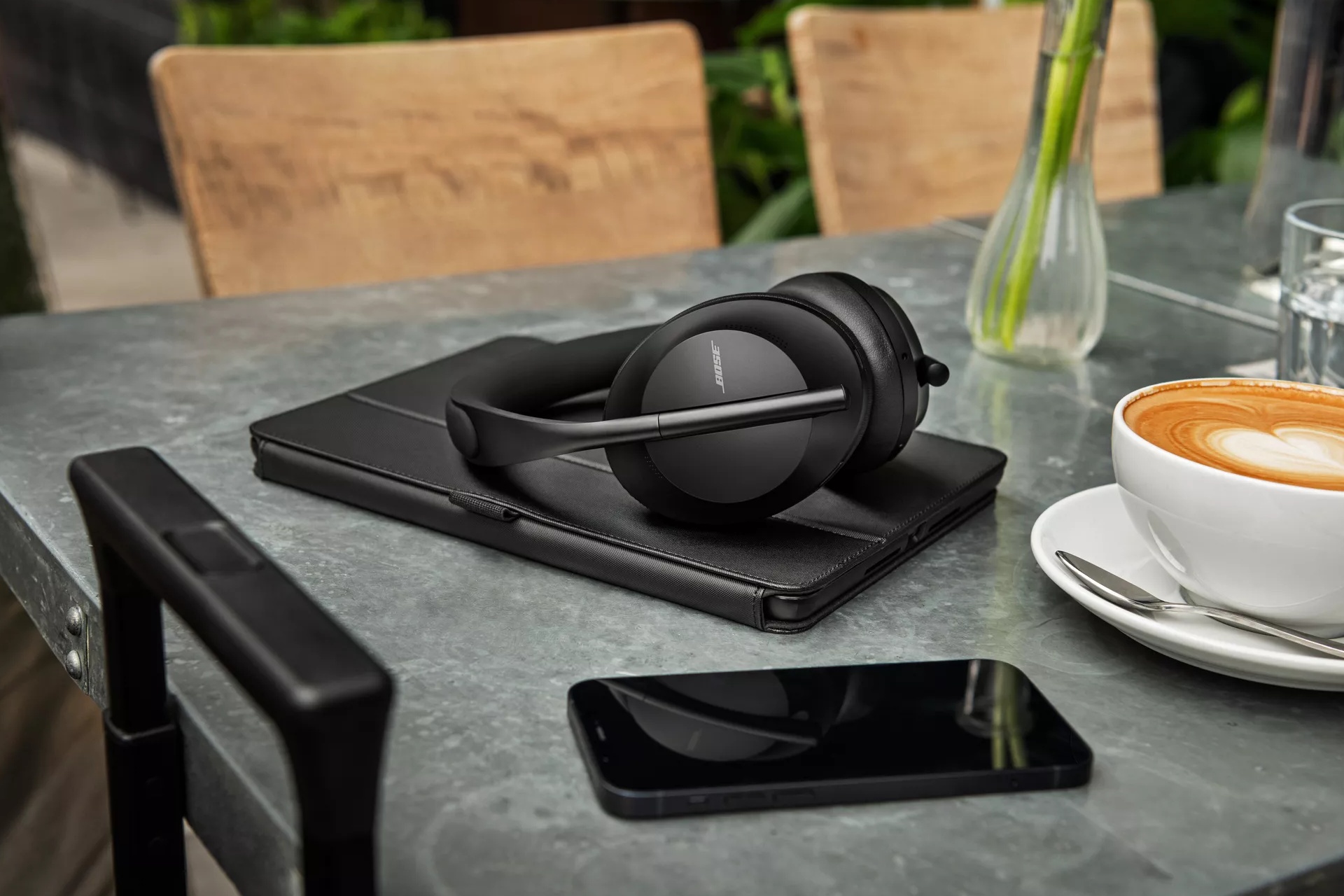 Bose Noise Cancelling Headphones 700 on a table in a coffee shop