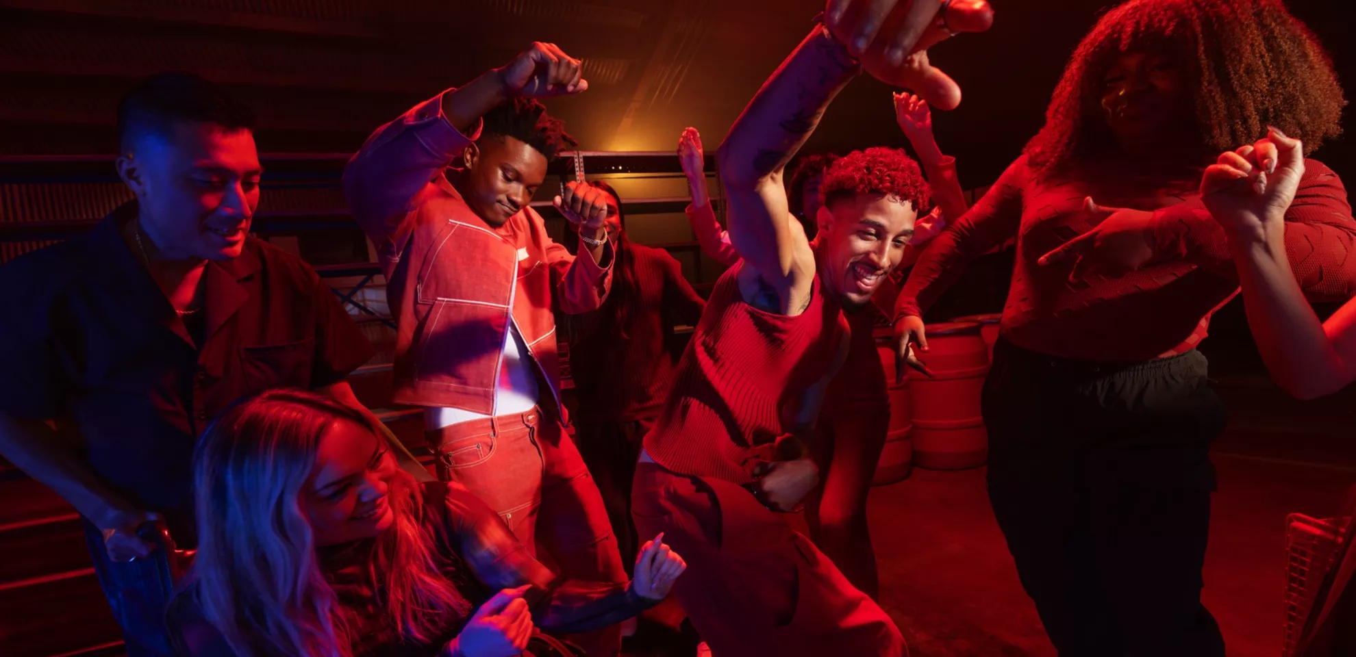 Young people dancing at a party with music playing from a Bose SoundLink Max Portable Speaker