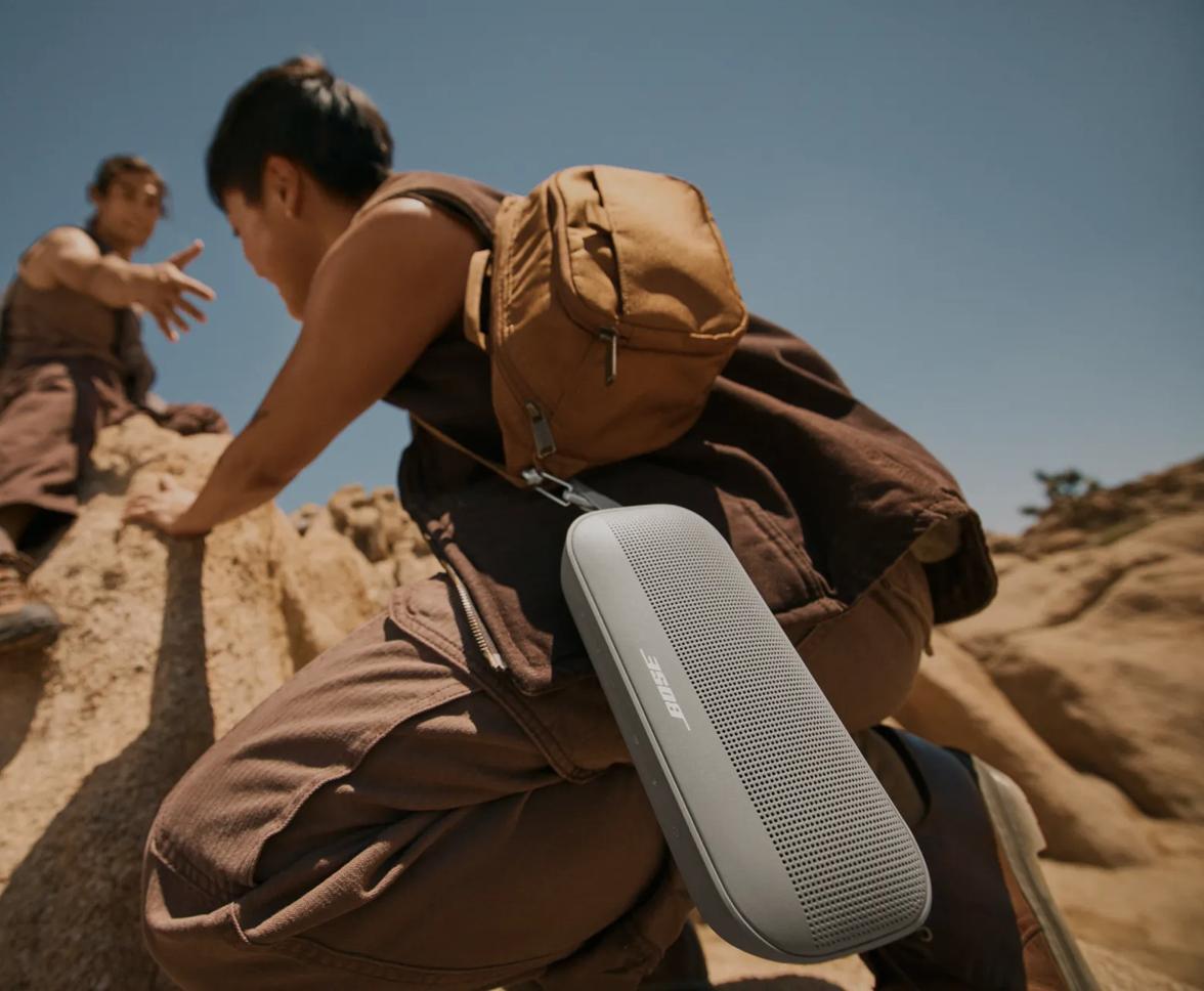 Two friends rock climbing listening to a Bose SoundLink Flex Portable Speaker (2nd Gen)