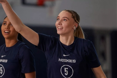 Azzi Fudd and Paige Bueckers (taking a shot) on the basketball court