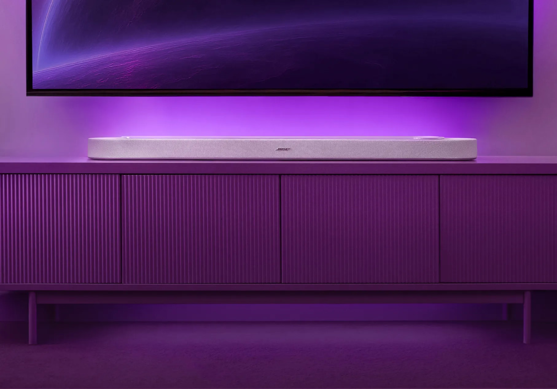 Bose Lifestyle Ultra Soundbar on a TV console in living room. 
