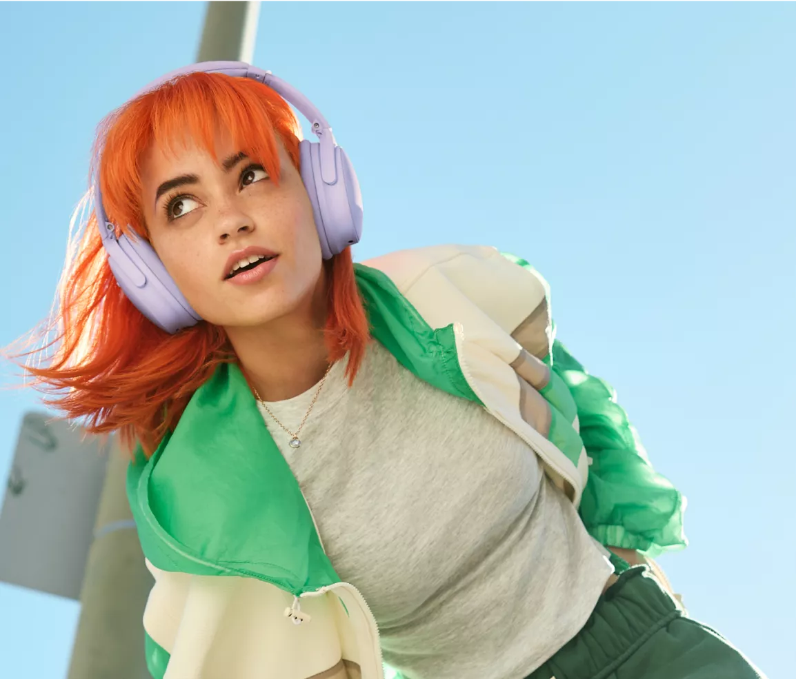  Woman wearing Bose QuietComfort Headphones outside