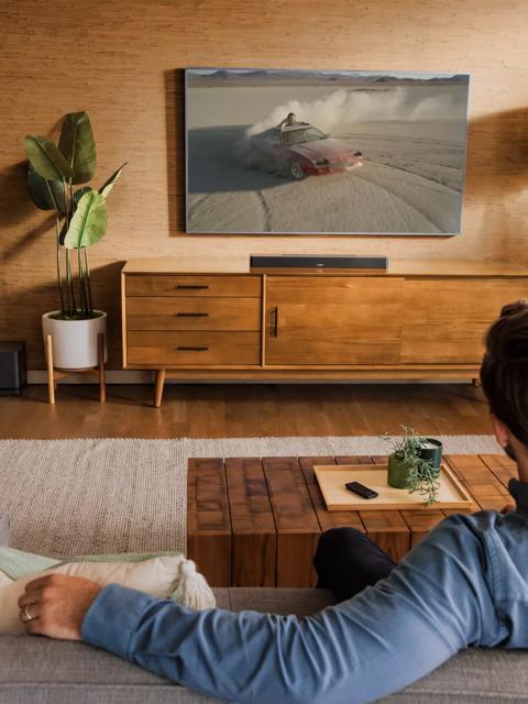 Man watching tv with Bose Smart Soundbar 600