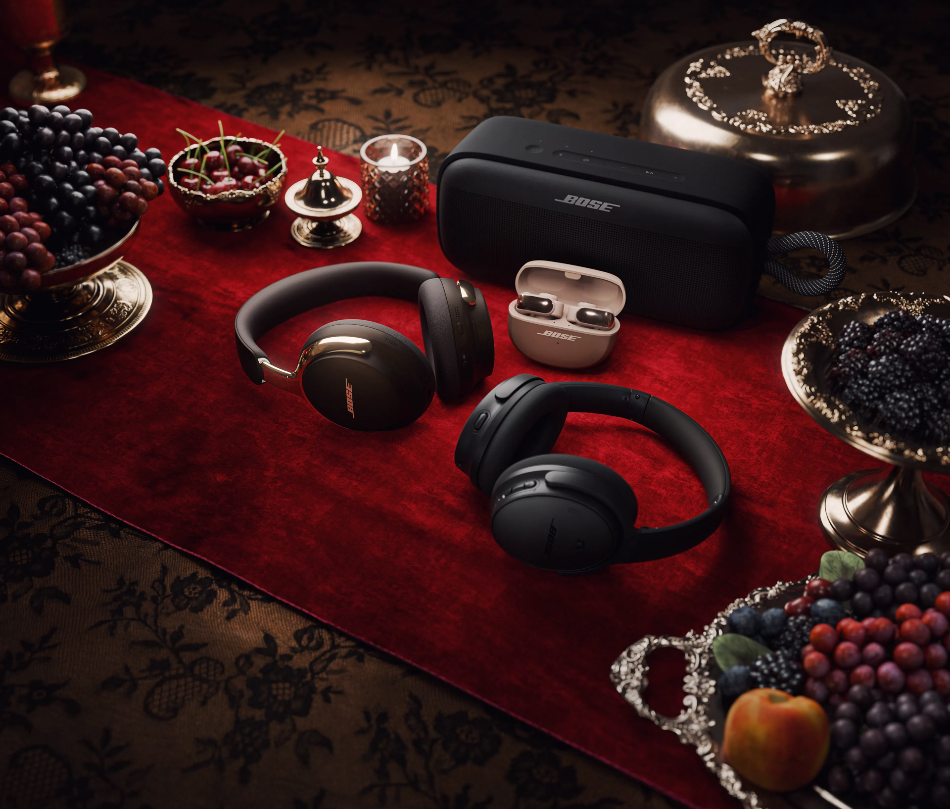 QuietComfort Headphones, QuietComfort Ultra Headphones (2nd Gen), SoundLink Plus Portable Speaker, and Ultra Open Earbuds LE featured in a holiday table.