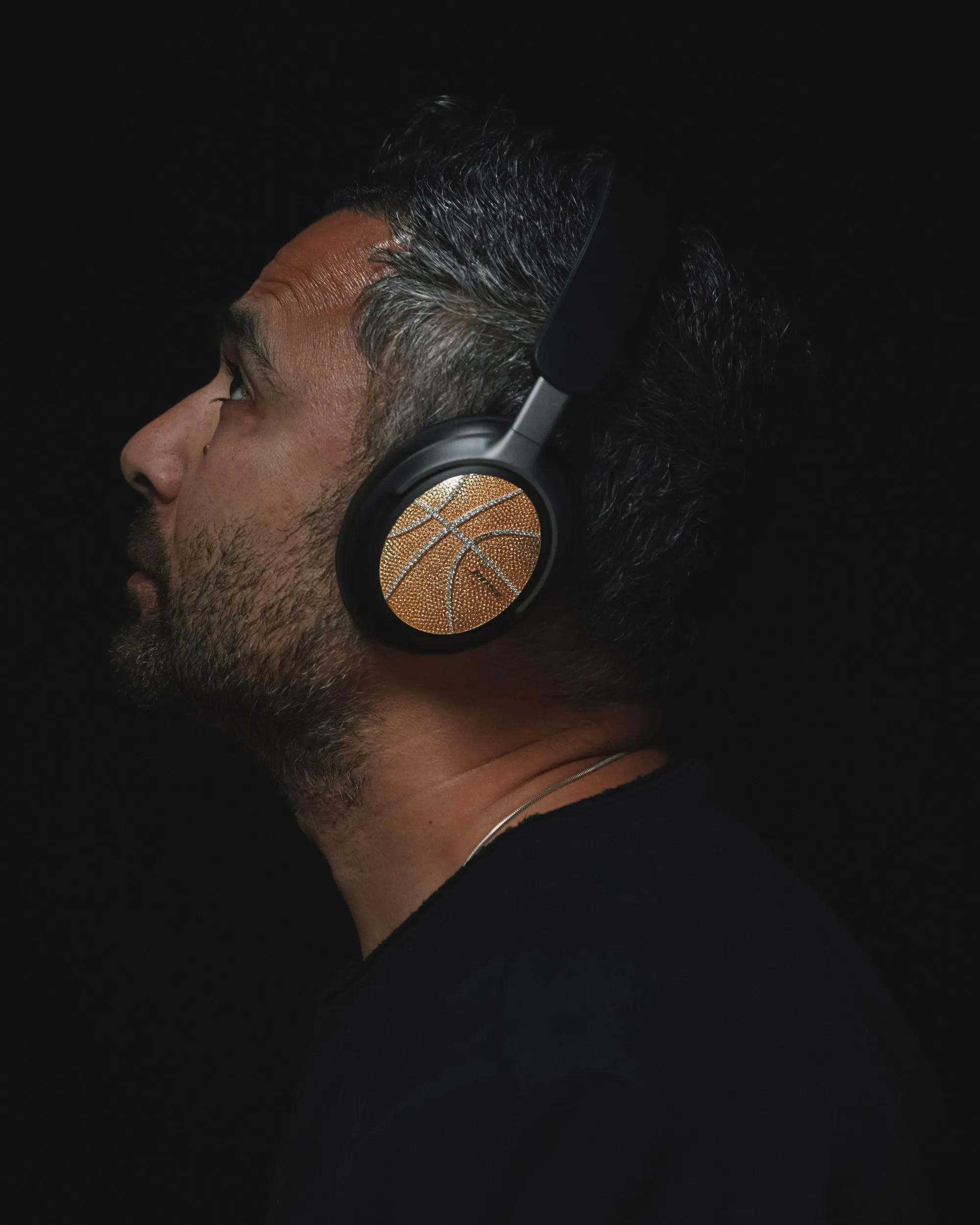 Victor Solomon wearing the limited-edition QuietComfort Ultra Headphones, encrusted with gold and diamonds.