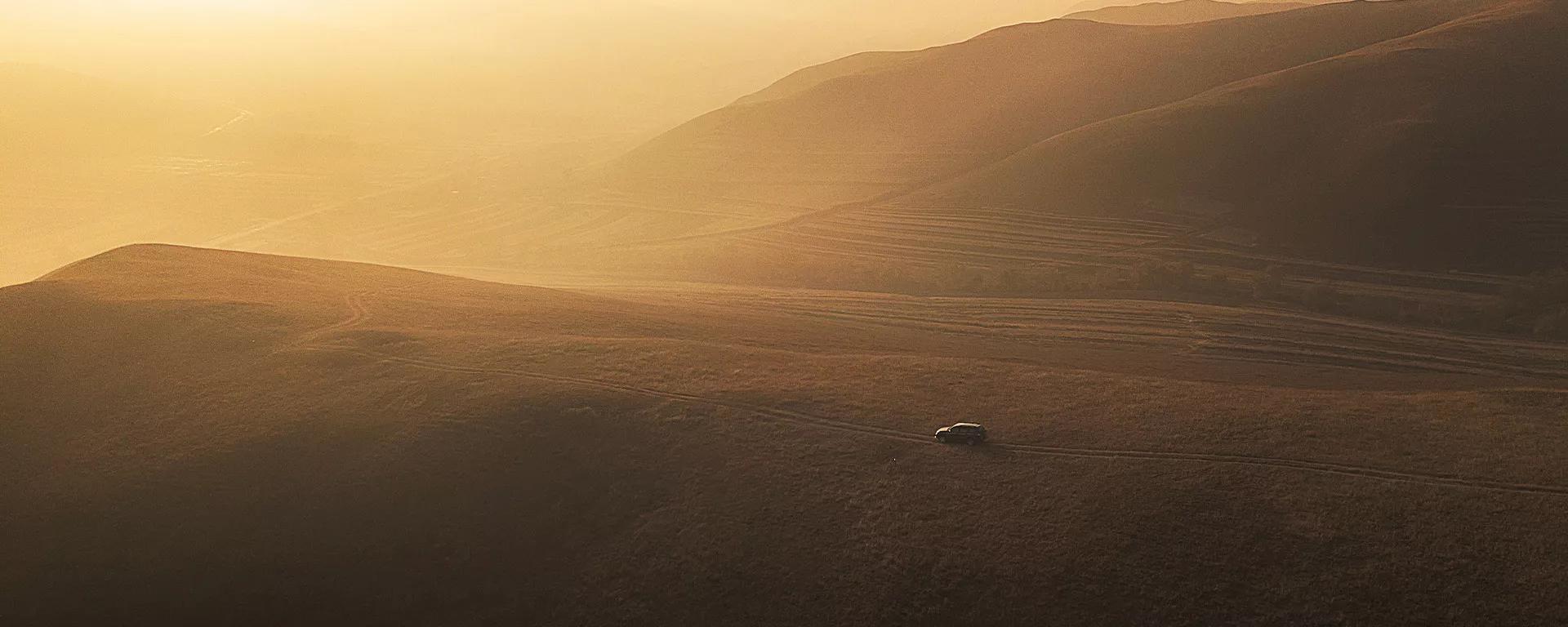 A car driving through a sandy desert