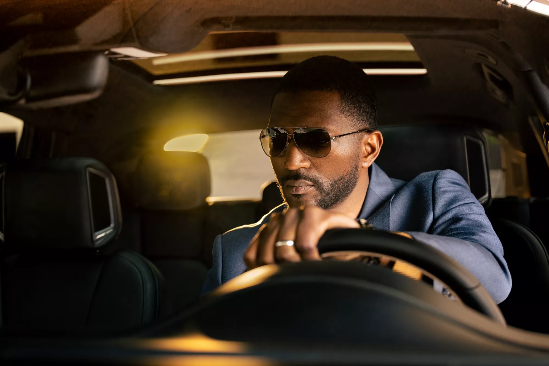 Man driving an automobile with Bose speakers