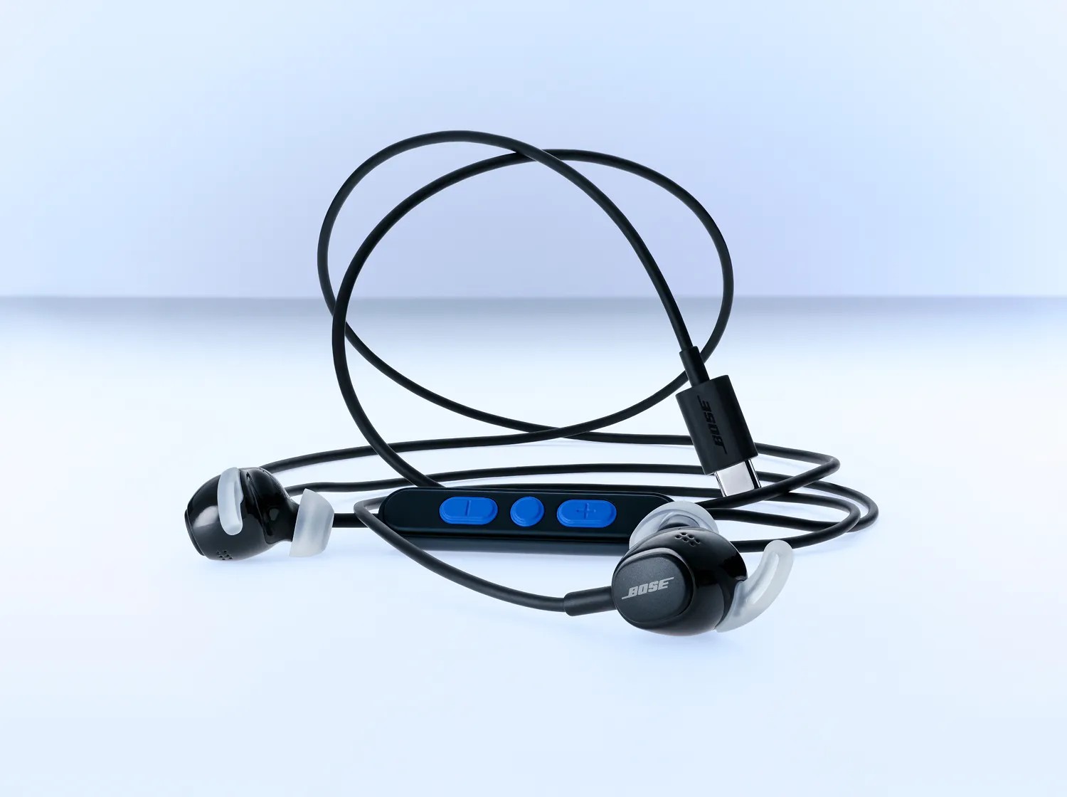 Bose Noise Cancelling Wired Earbuds in black with the cable coiled