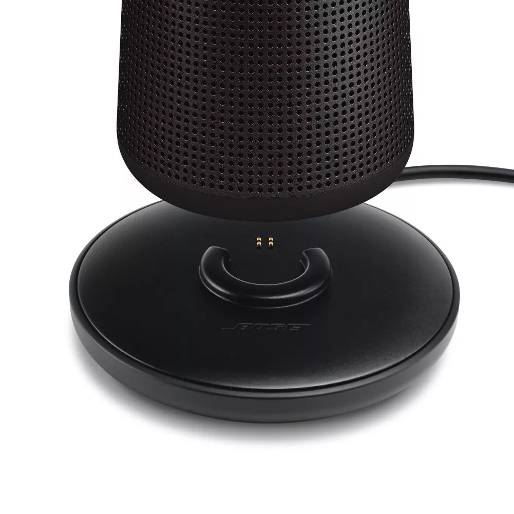 SoundLink Revolve II speaker being placed on the optional charging cradle