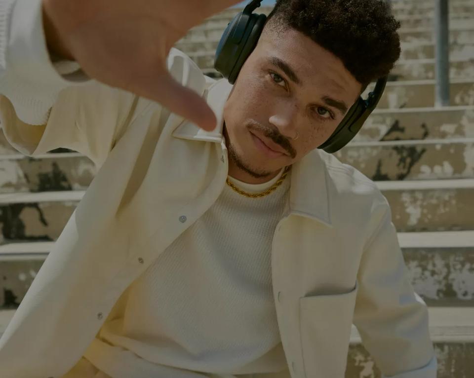 Man wearing Bose QuietComfort Headphones outside