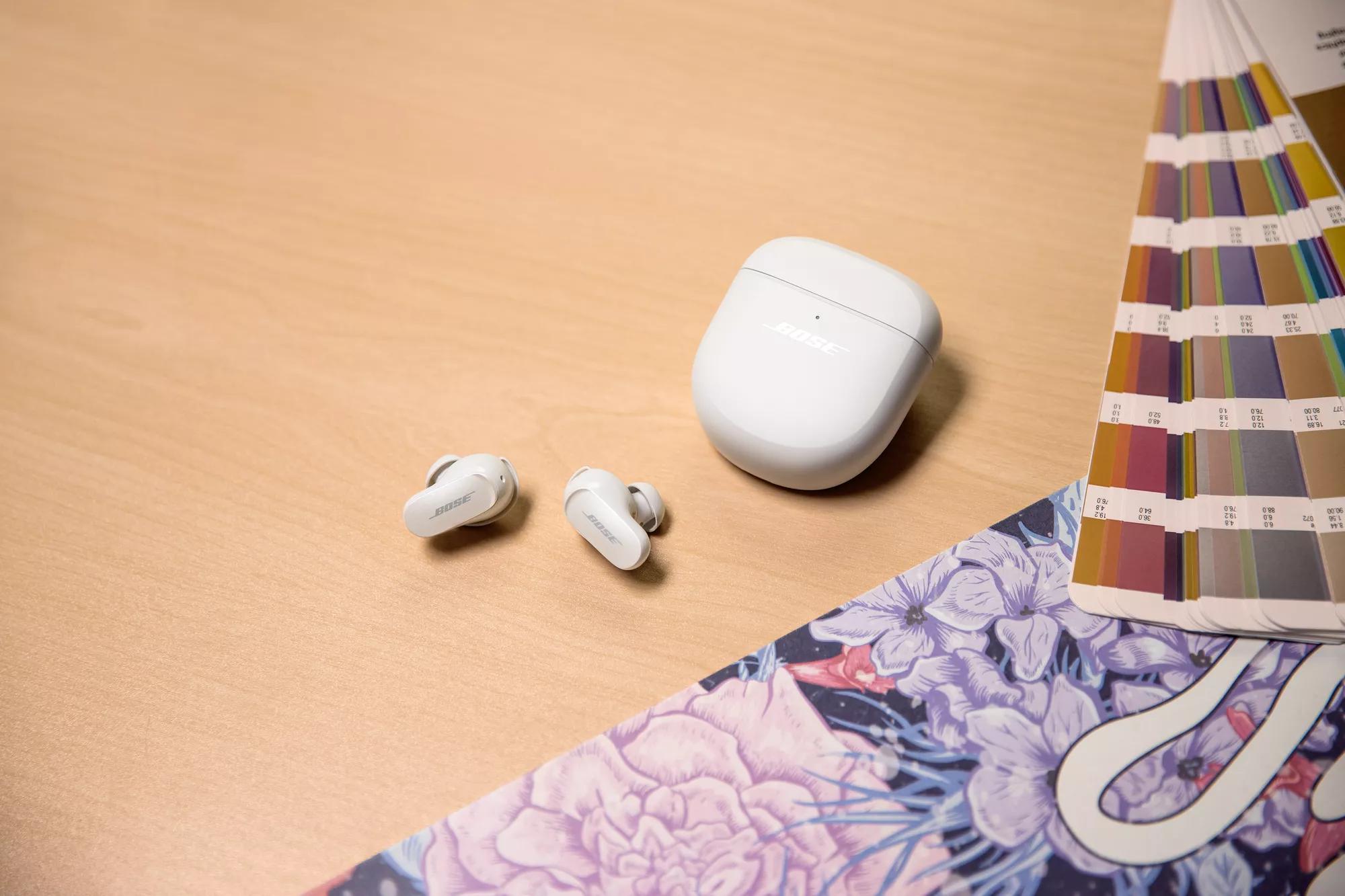 Bose QuietComfort Earbuds II and their charging case on a table