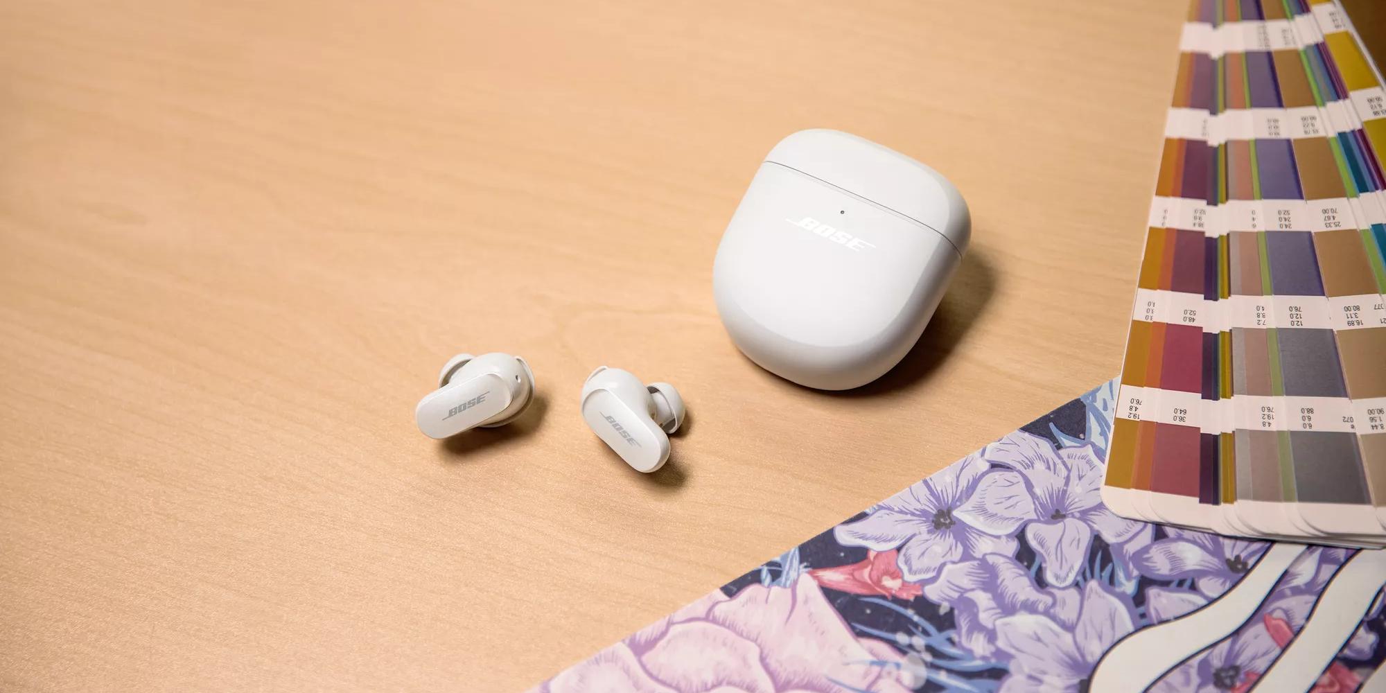 Bose QuietComfort Earbuds II and their charging case on a table