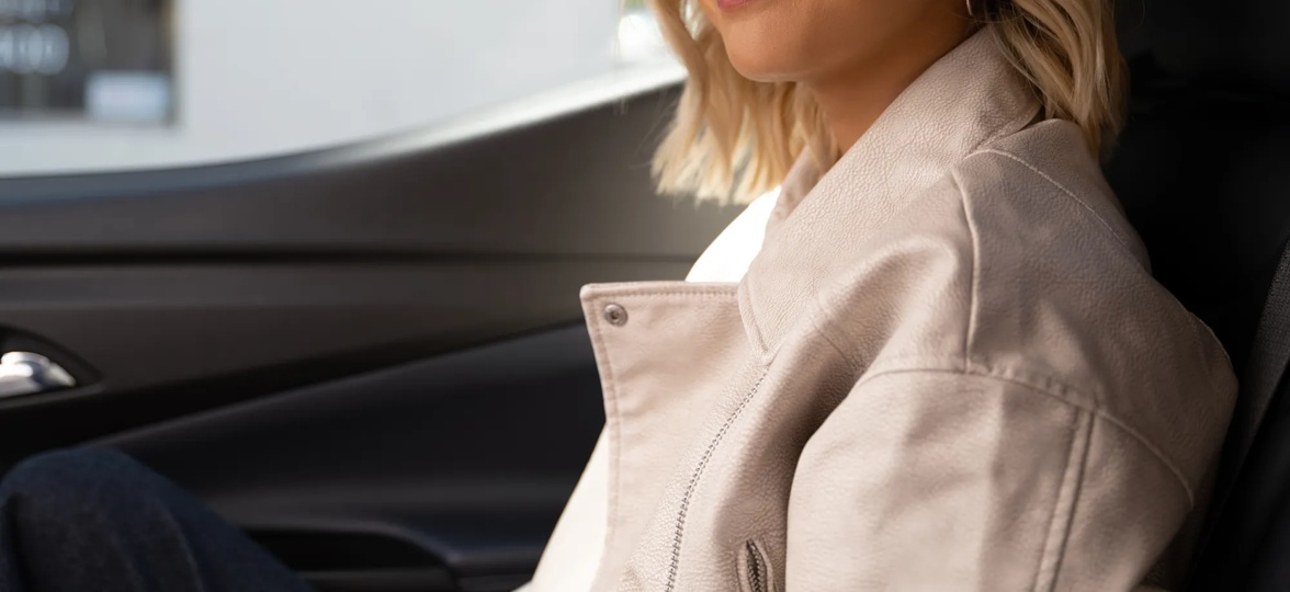 Woman in a car wearing the QuietComfort Earbuds.