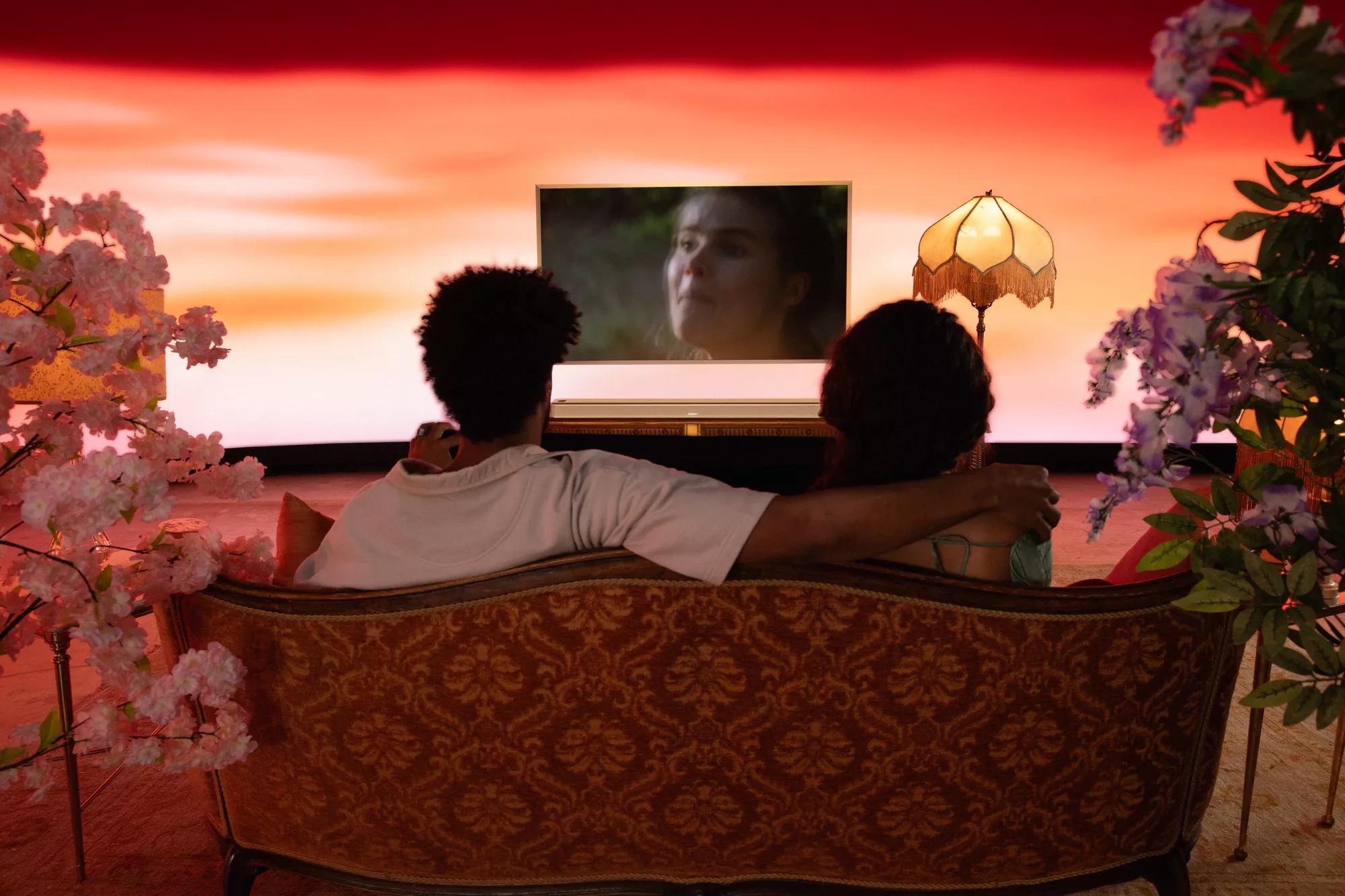 Un couple regardant la télévision avec une barre de son intelligente Bose Ultra