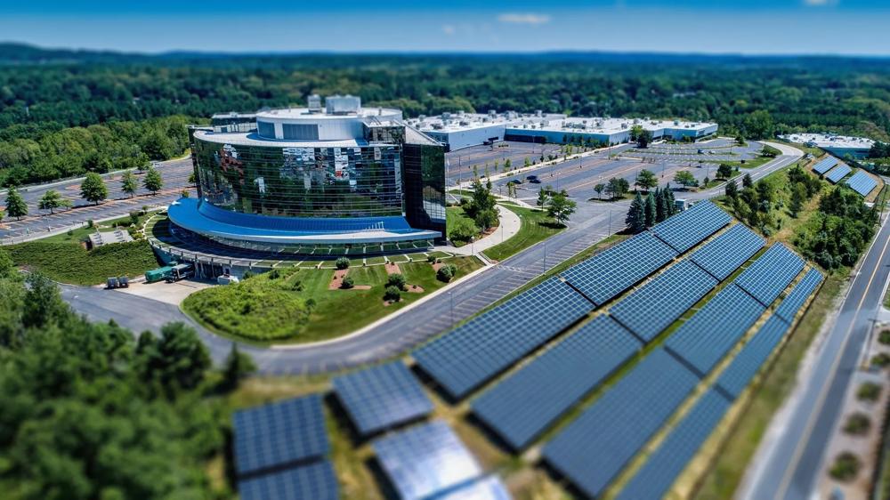 Office building next to solar panels on a hill
