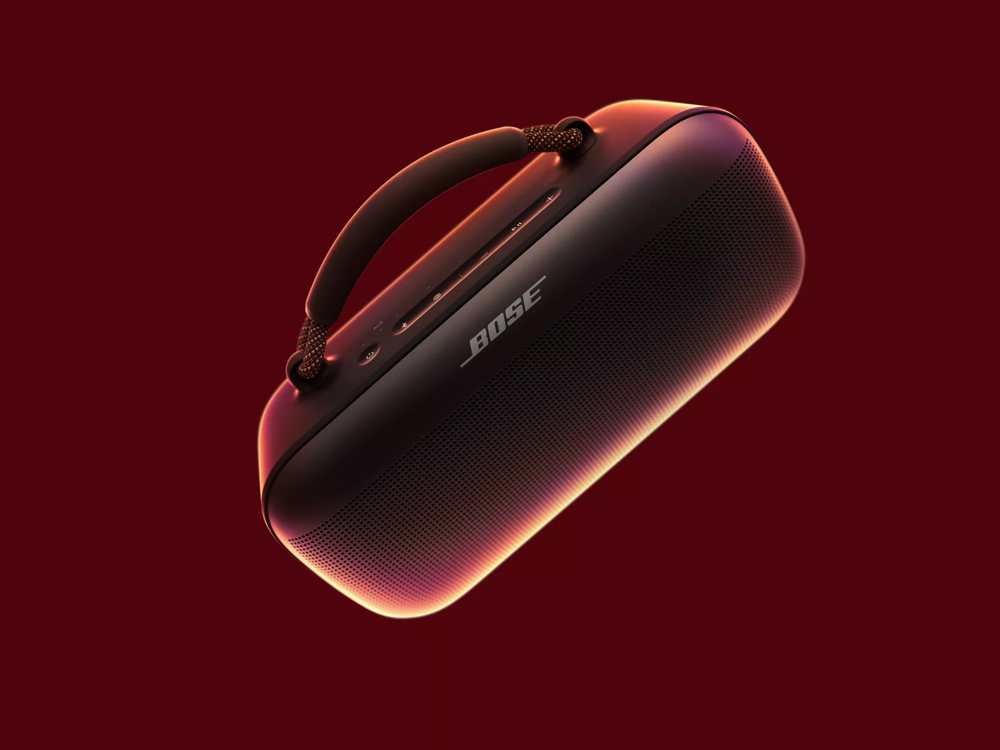 Black SoundLink Max Portable speaker with handle displayed against a red background.