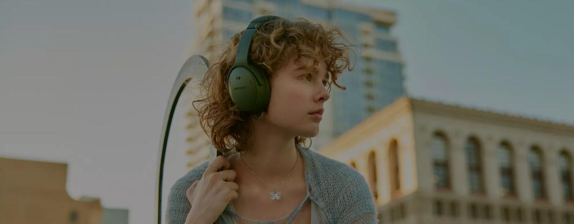 Woman wearing Bose QuietComfort Headphones outside