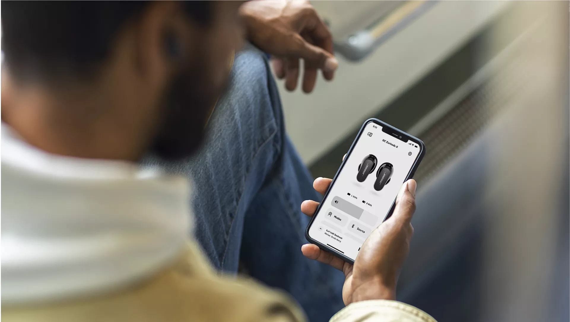 Man using the Bose Music app for the QuietComfort Earbuds II