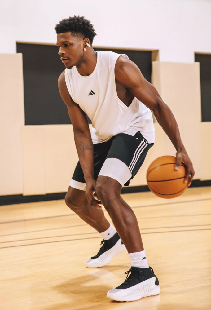 Anthony Edwards wearing Bose Ultra Open Earbuds while dribbling on the basketball court.