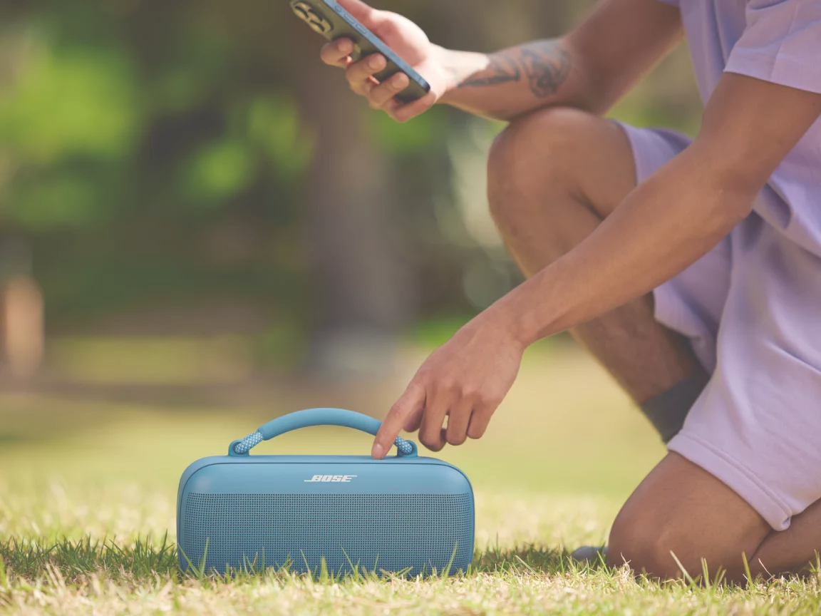 Person using the Bose app with their Bose SoundLink Max Portable Speaker