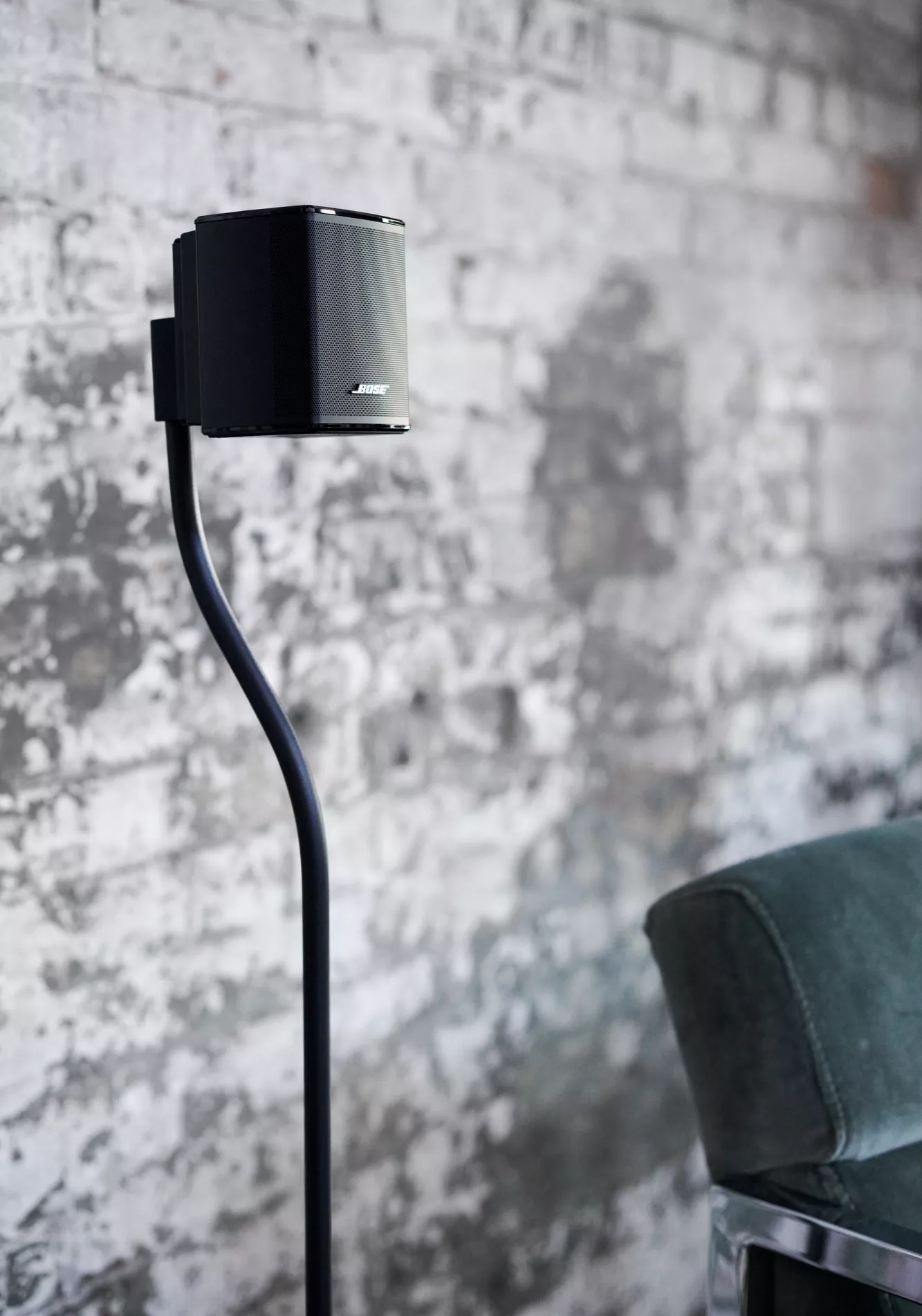 Bose Surround Speaker attached to a floorstand in a living room