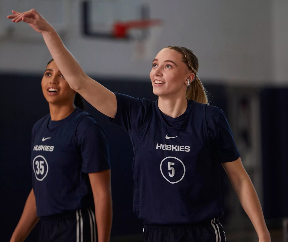 Azzi Fudd and Paige Bueckers (taking a shot) on the basketball court