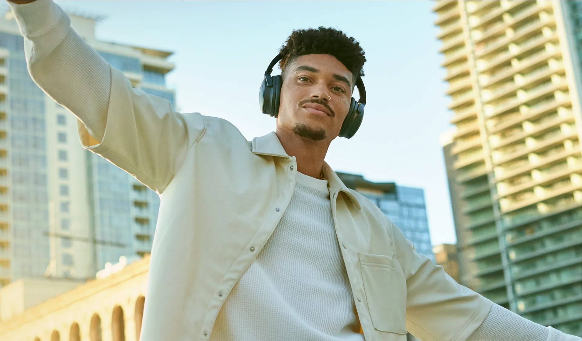 Man wearing Bose QuietComfort Headphones outside.