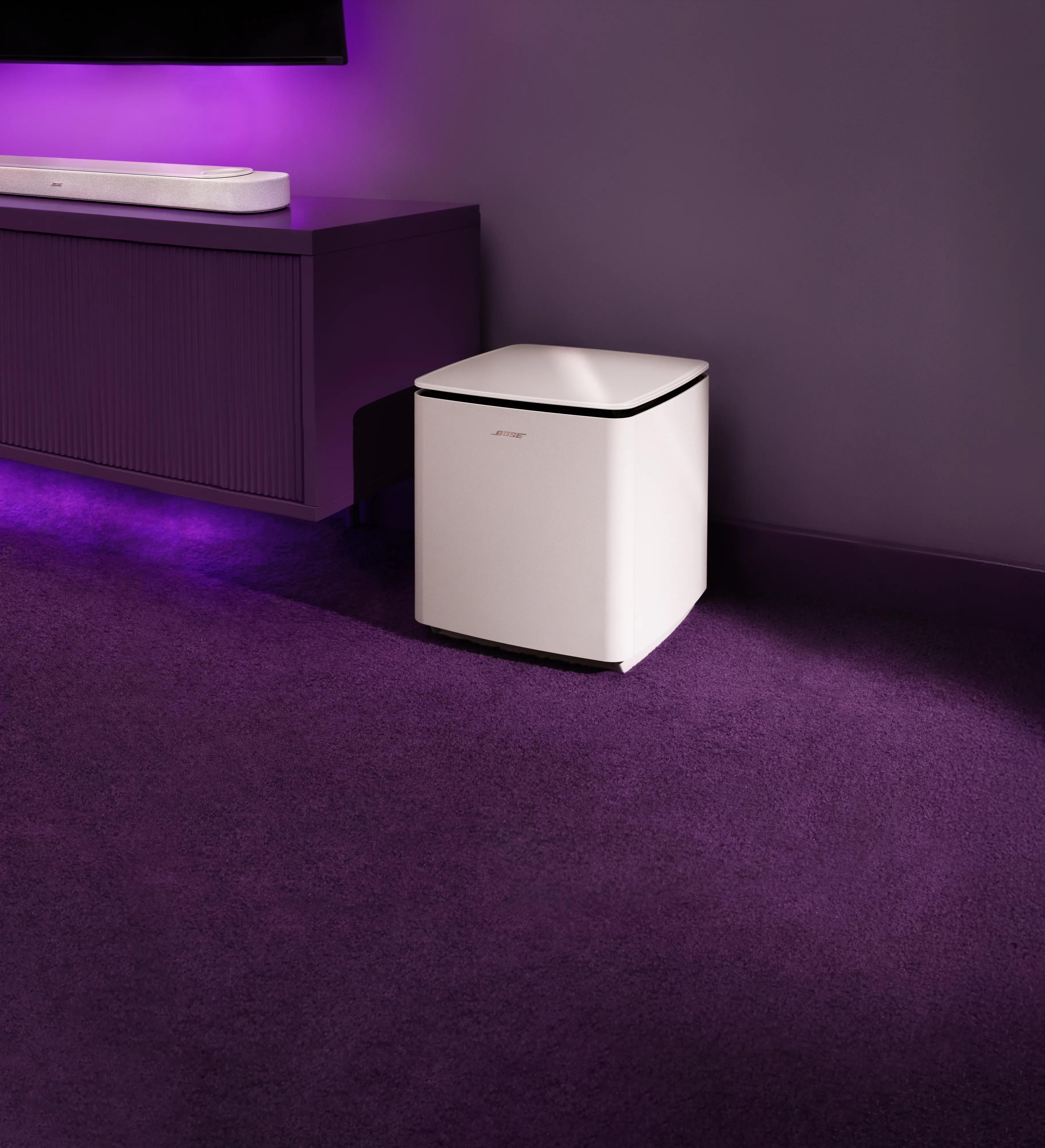 Lifestyle Ultra Soundbar placed in a tv cabinet and a Lifestyle Ultra Subwoofer beside the cabinet on the floor.