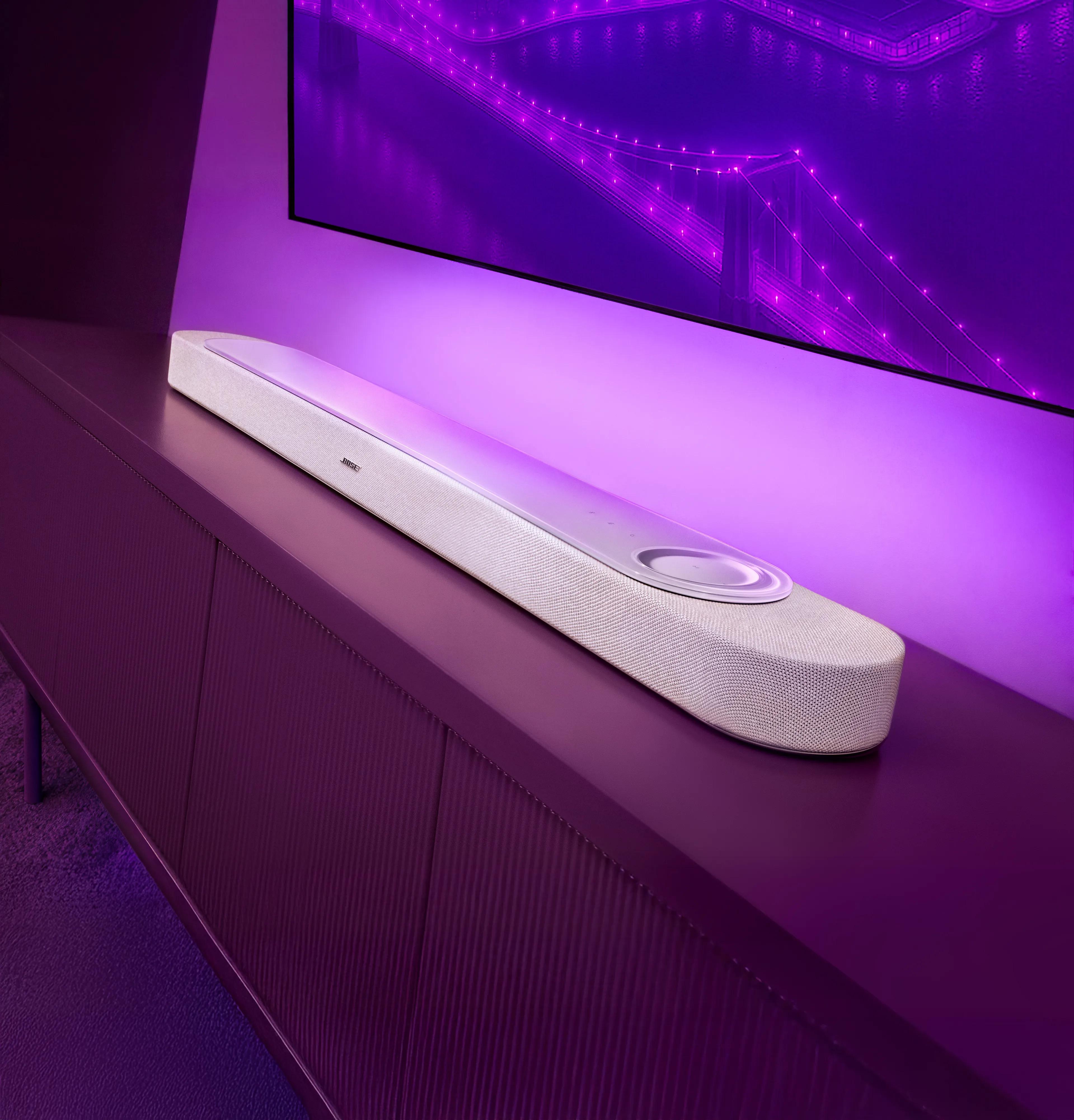 Lifestyle Ultra Soundbar placed on a tv cabinet  in a softly lit room.