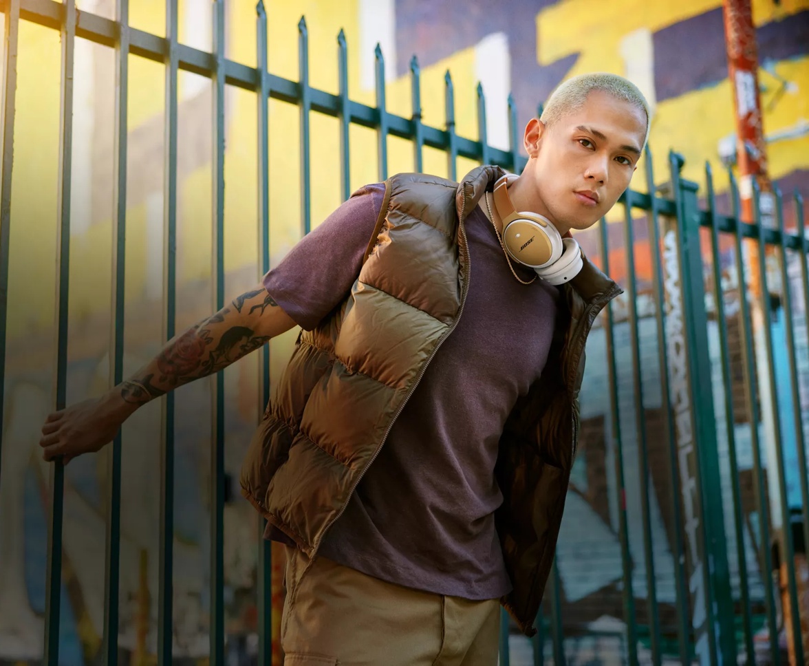Person with customized Bose QuietComfort Headphones around their neck outside