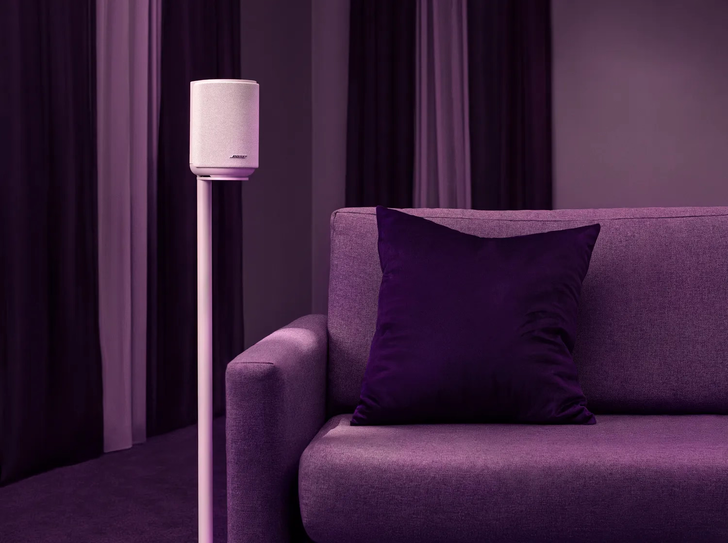 Lifestyle Ultra Speaker Floor Stand with a Lifestyle Ultra Speaker creating an immersive surround sound experience in a modern living room.