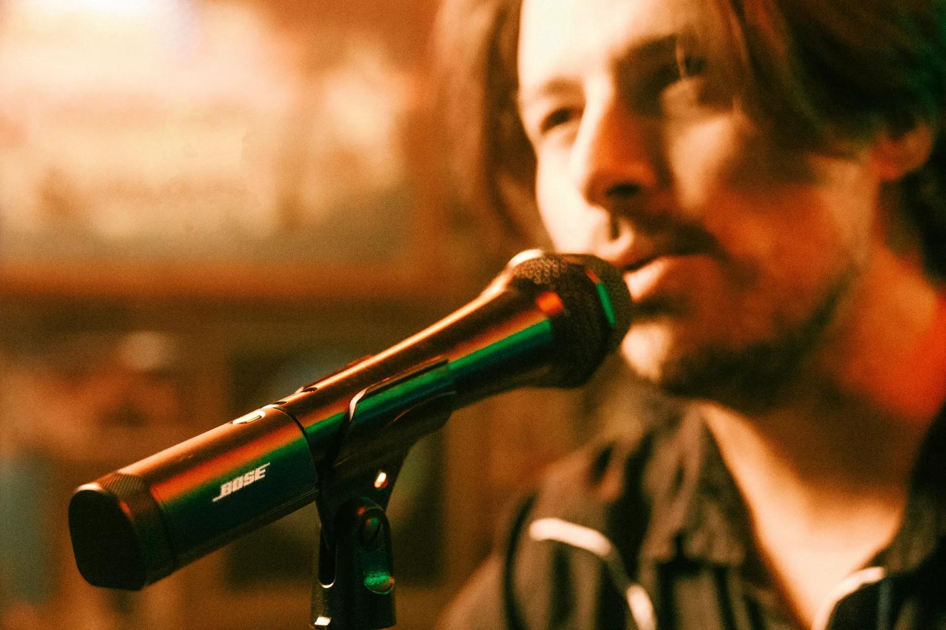 Musician singing into a microphone