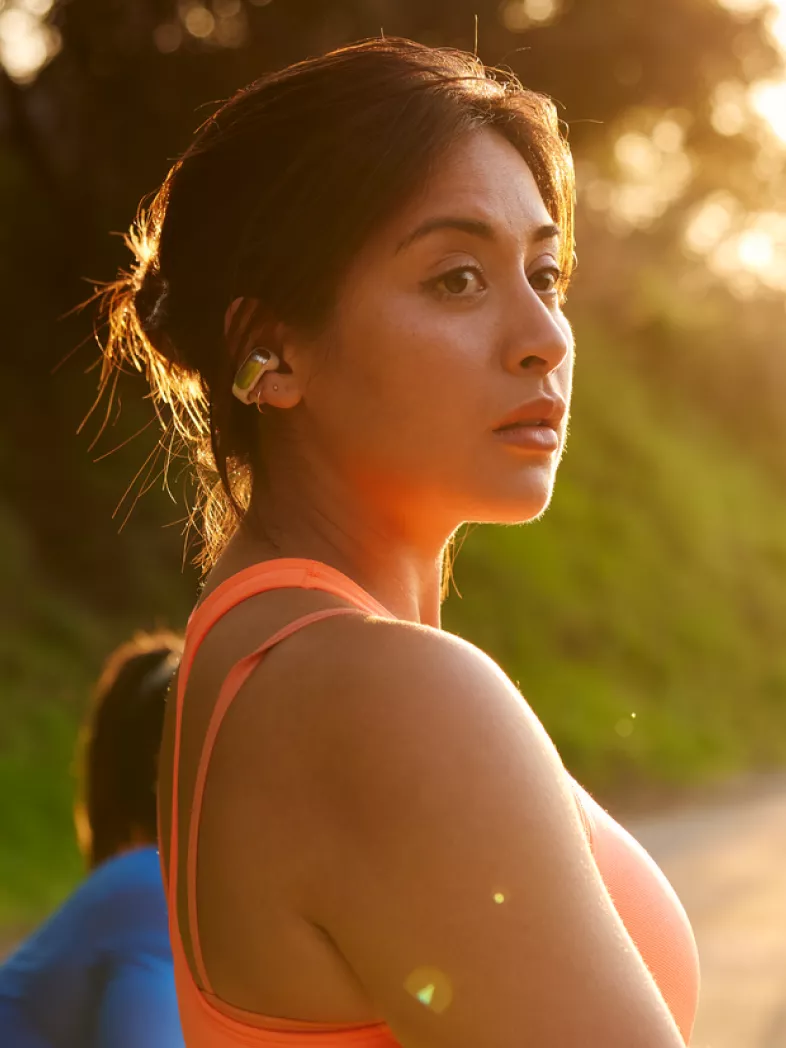  Woman getting ready for a run wearing Bose Ultra Open Earbuds