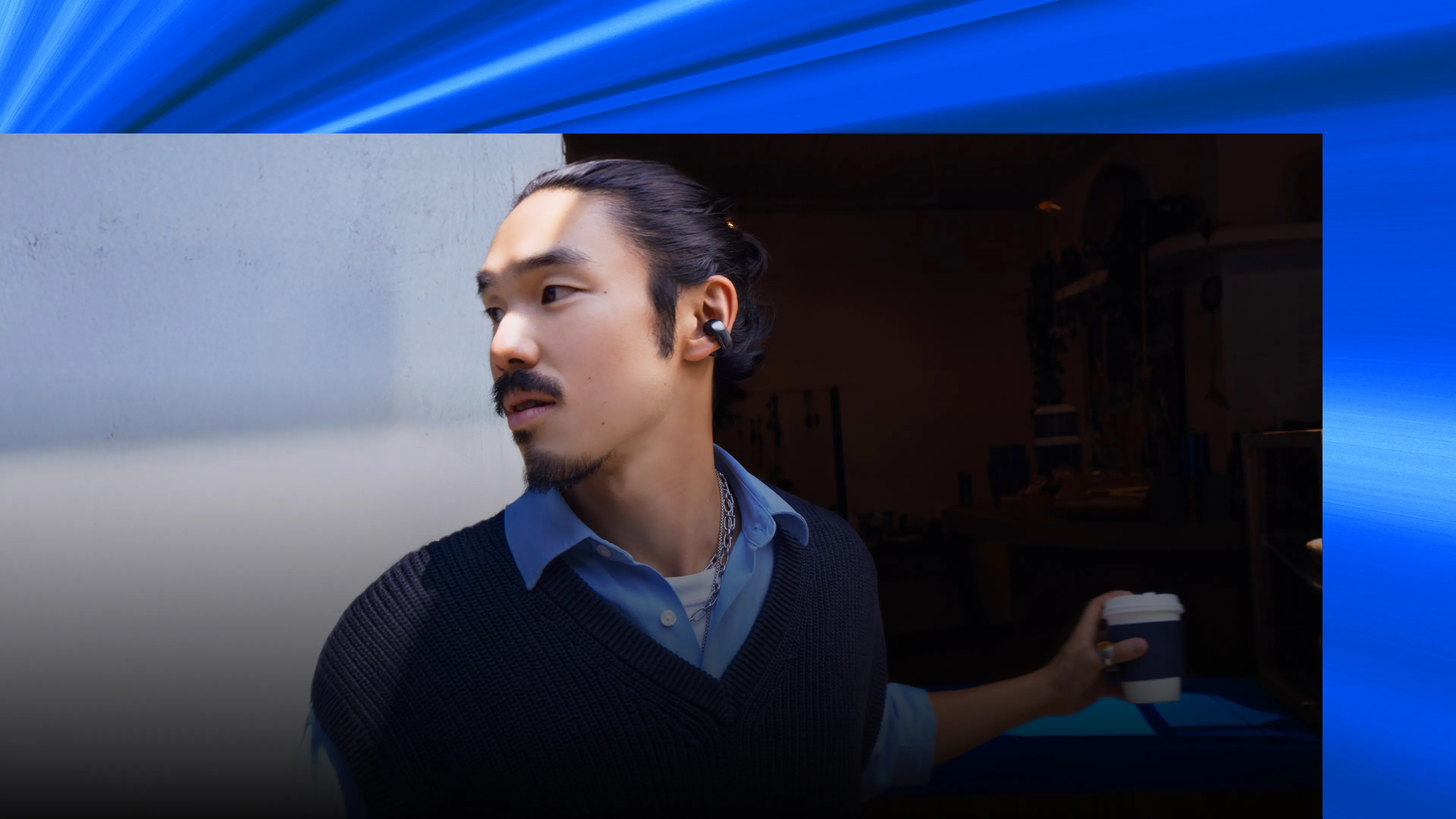 Man wearing Bose Ultra Open Earbuds.