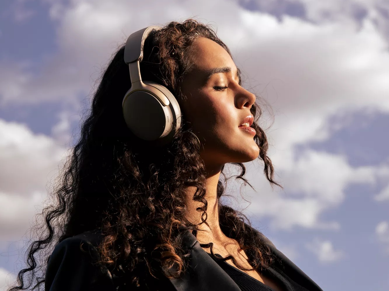 Woman enjoying peace and quiet from the noise cancellation of Bose QuietComfort Ultra Headphones