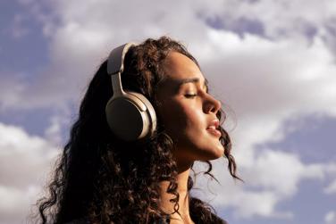 Woman enjoying peace and quiet from the noise cancellation of Bose QuietComfort Ultra Headphones