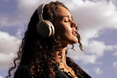 Woman enjoying peace and quiet from the noise cancellation of Bose QuietComfort Ultra Headphones