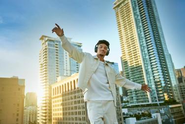 Man in city wearing Bose QuietComfort Headphones