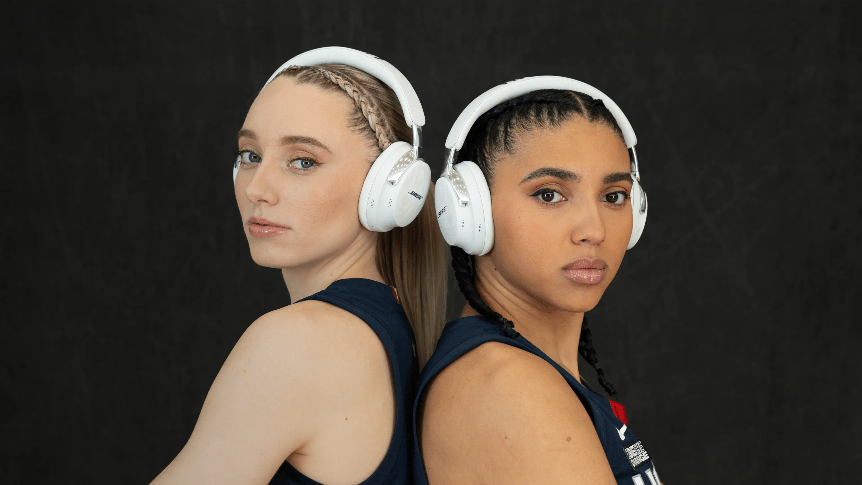 Paige Bueckers and Azzi Fudd wearing Bose QuietComfort Ultra Headphones custom designed for UConn.