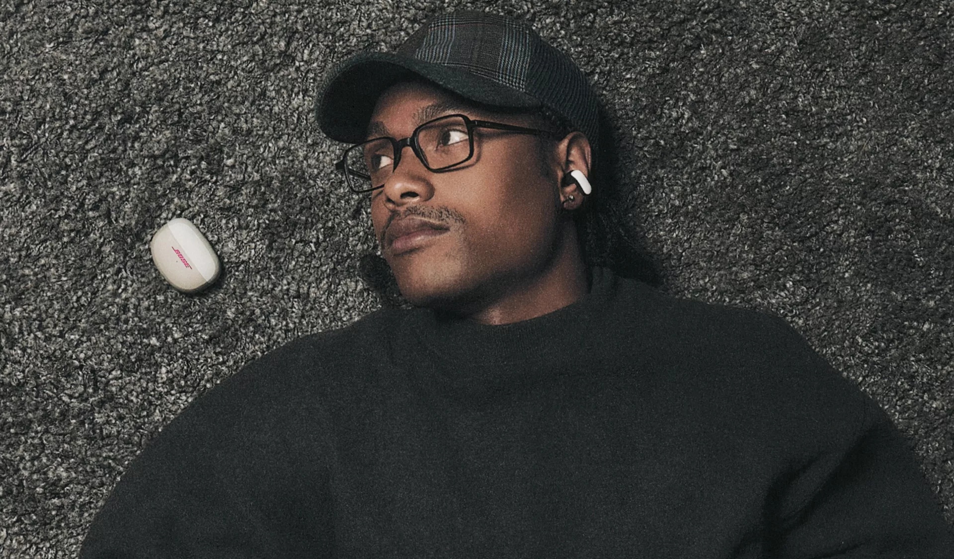 Steve Lacy wearing Bose x Steve Lacy Ultra Open Earbuds