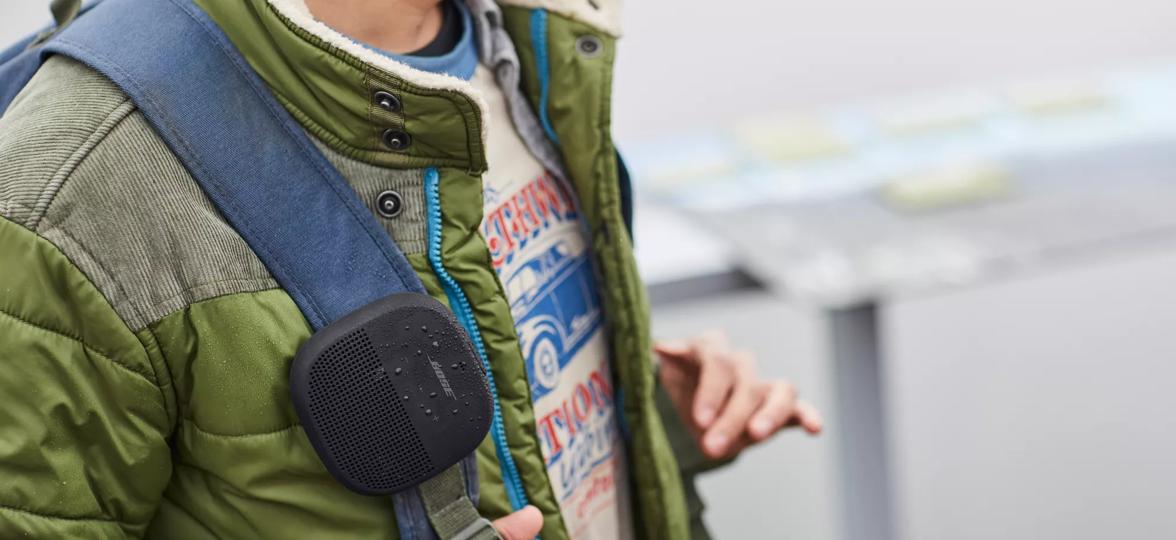 SoundLink Micro Bluetooth Speaker attached to the strap of a backpack 