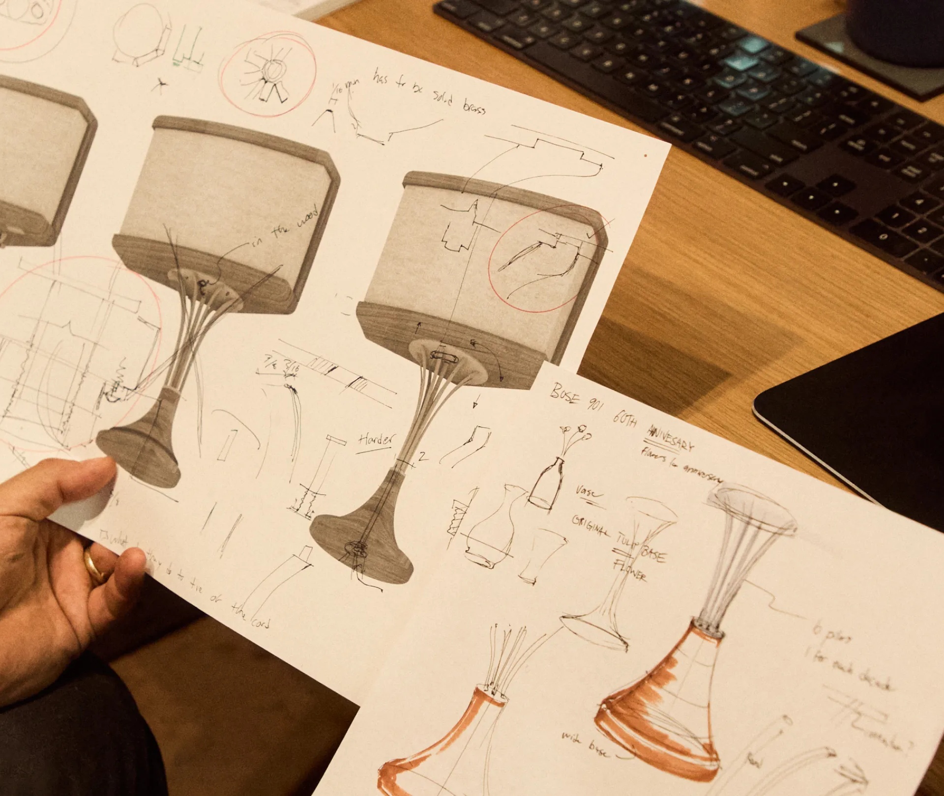 Mark Jupiter sitting at a desk holding sketches of the 901 Speaker.