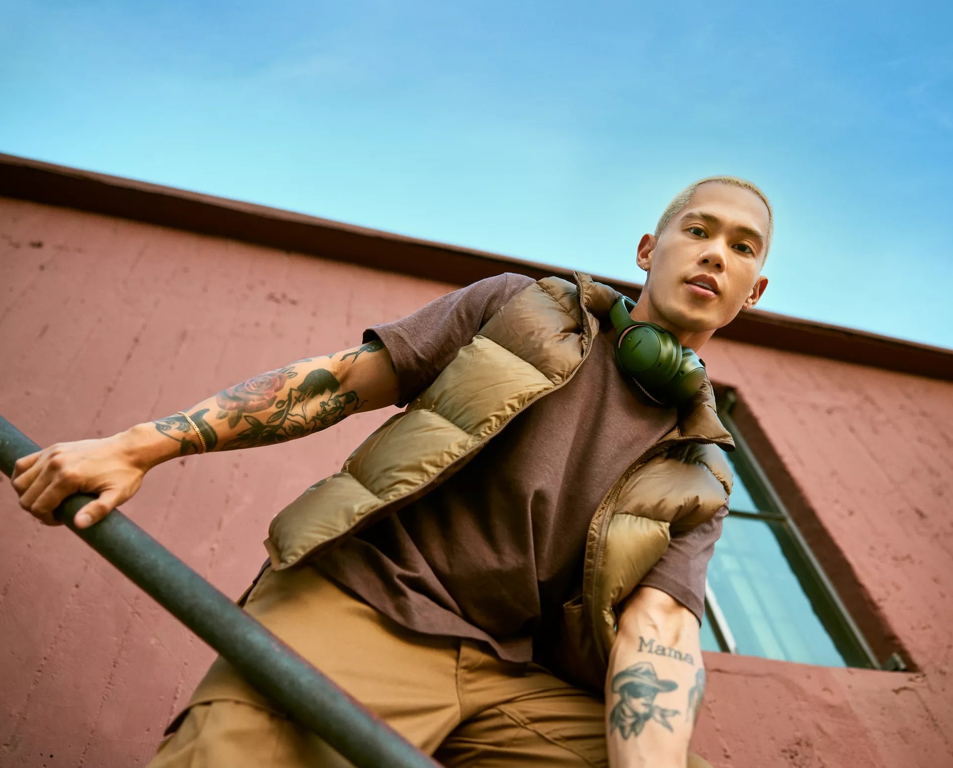  Man with Bose QuietComfort Headphones hanging around his neck while outside