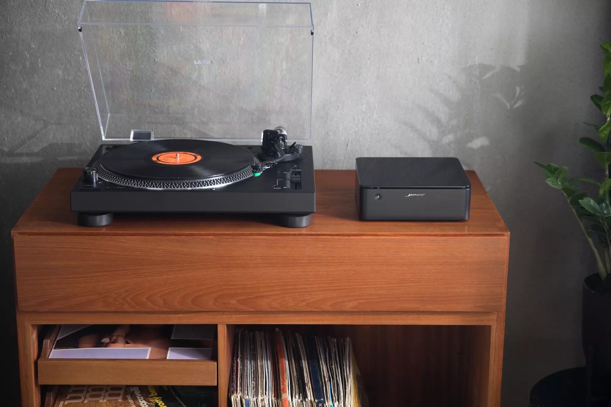 Bose Music Amplifier on a console next to a record player