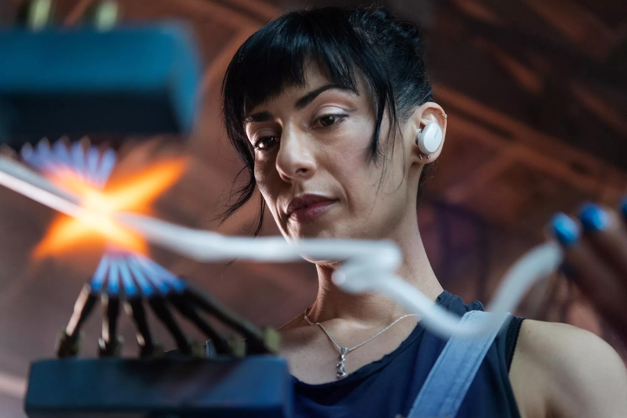 Leticia Maldonado working in her studio wearing Bose QuietComfort Earbuds 