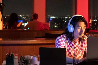Man wearing QuietComfort 45 headphones at the office