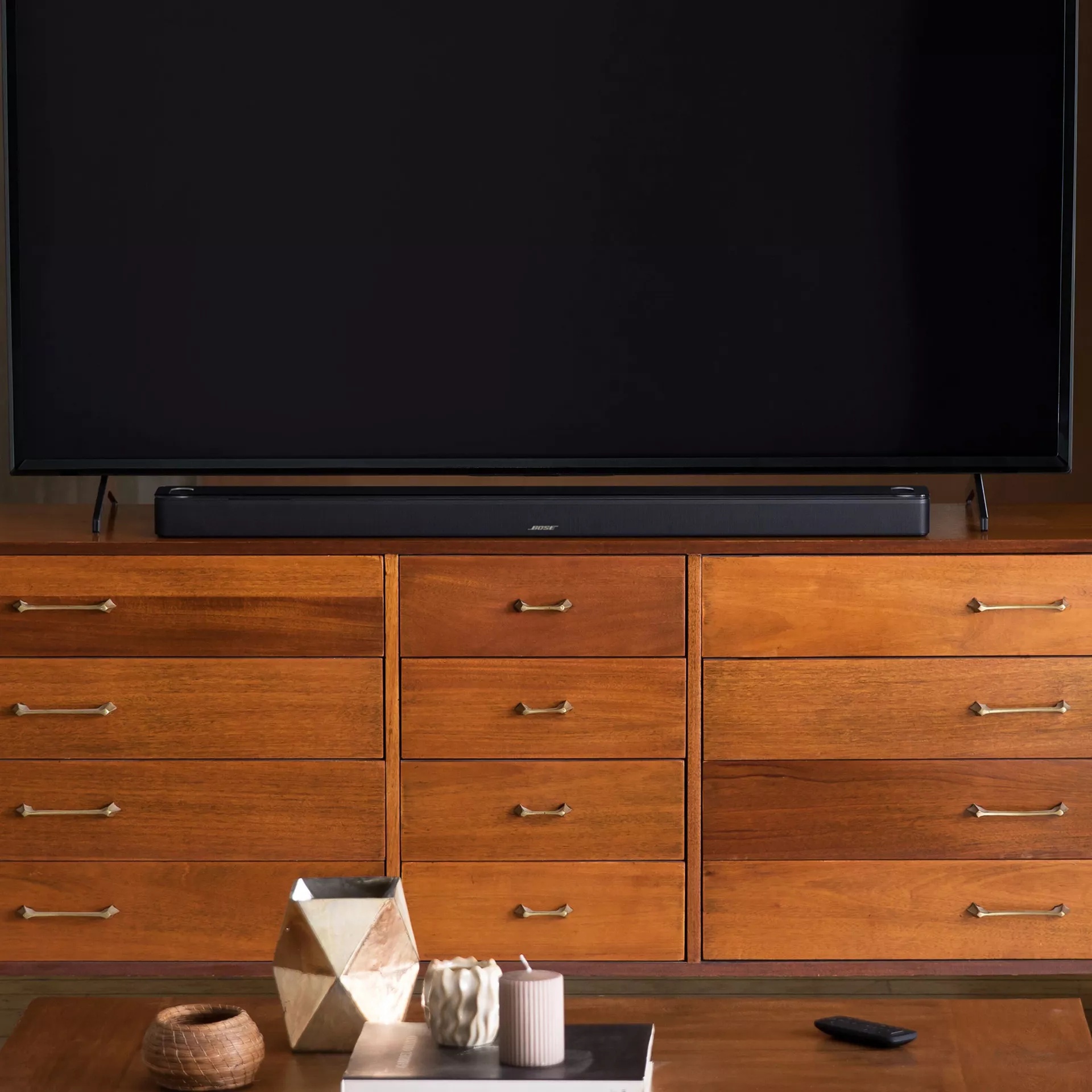 Bose Smart Ultra Soundbar connected to a flat-screen TV on a media console