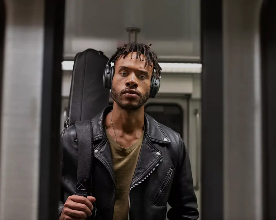 Man on subway wearing QuietComfort 45 Headphones